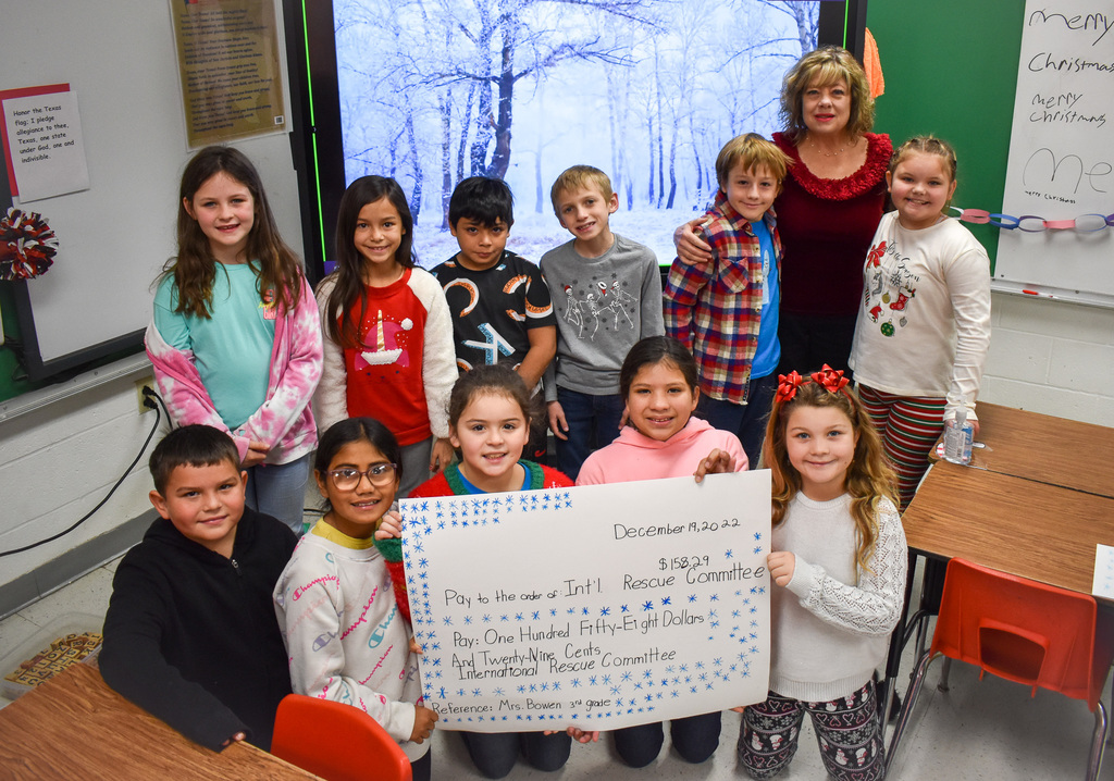 Third Grade with check of funds raised for International Rescue Committee